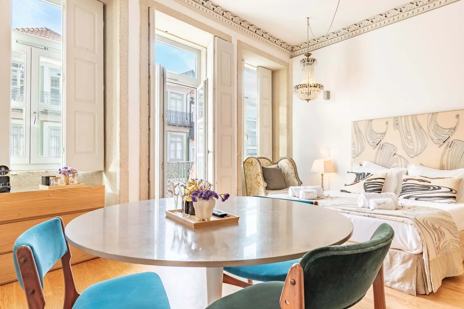 Elegant bedroom with tall windows and chandelier