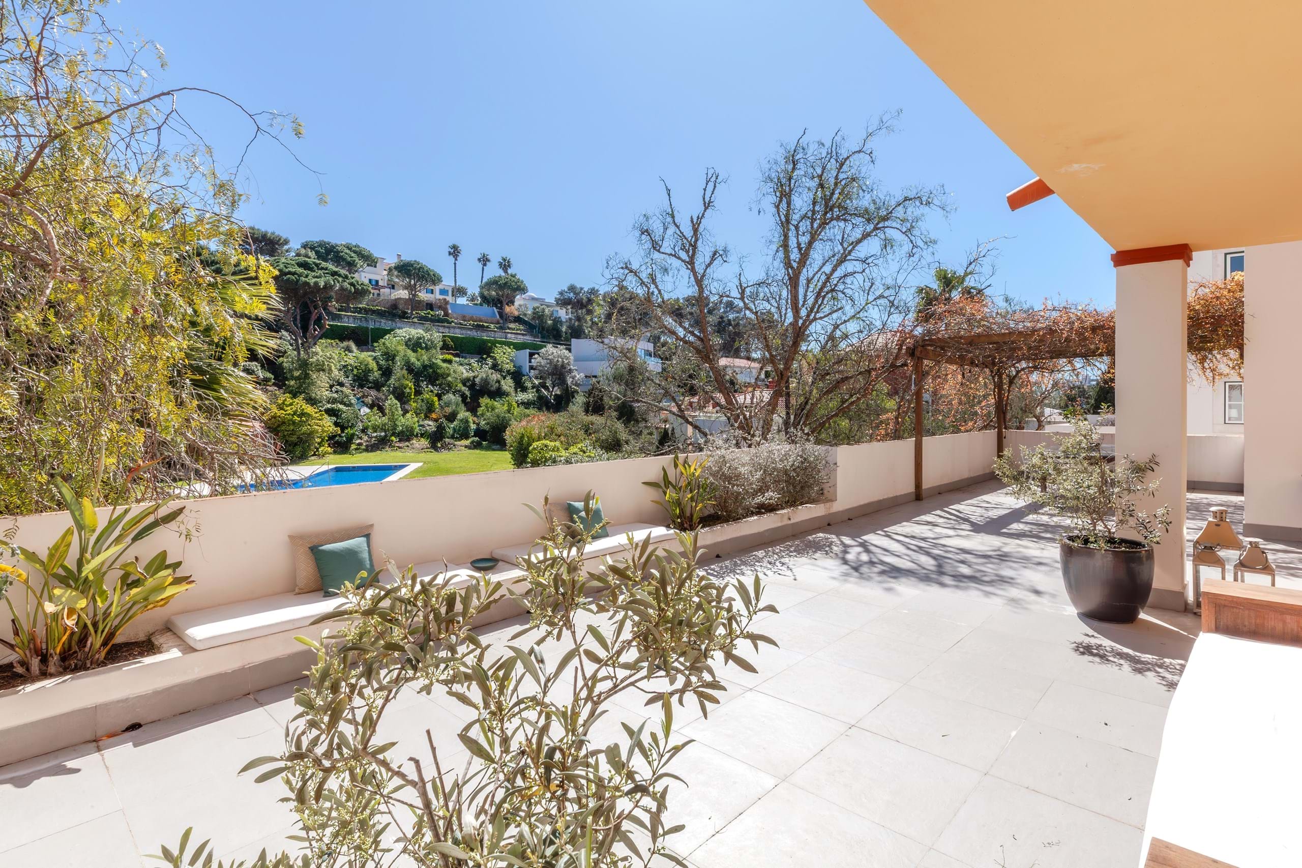Sunny terrace overlooking garden and swimming pool