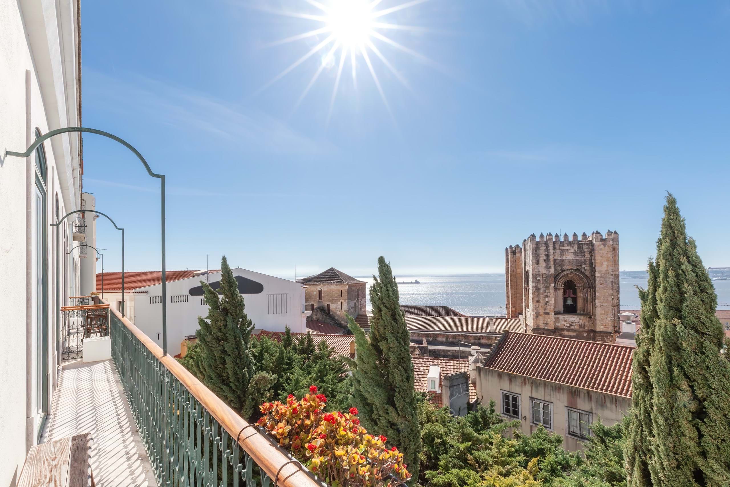 Sunny balcony view over historic coastal city rooftops