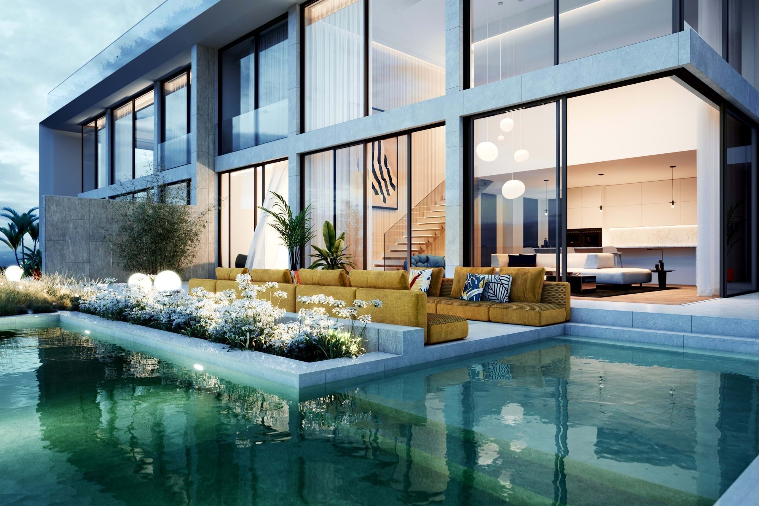 Modern luxury home with poolside terrace at dusk