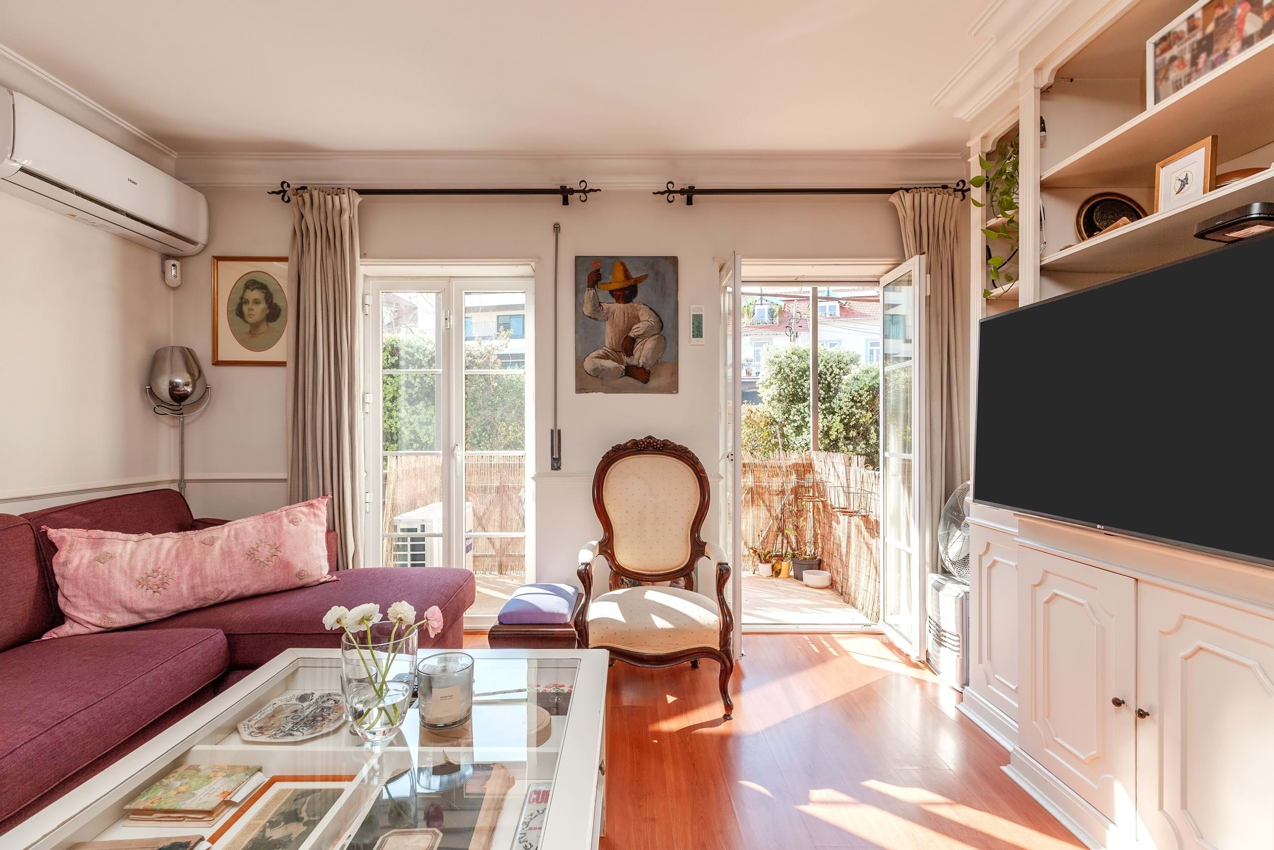 Sunlit living room with balcony doors and vintage chair