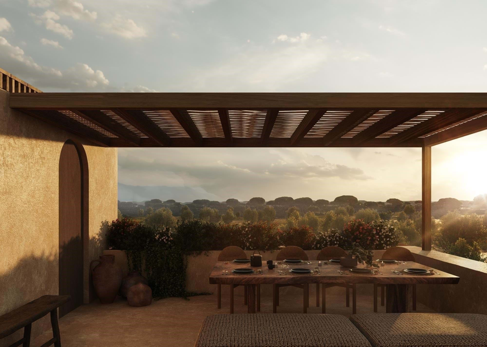 Rustic terrace dining area overlooking countryside at sunset