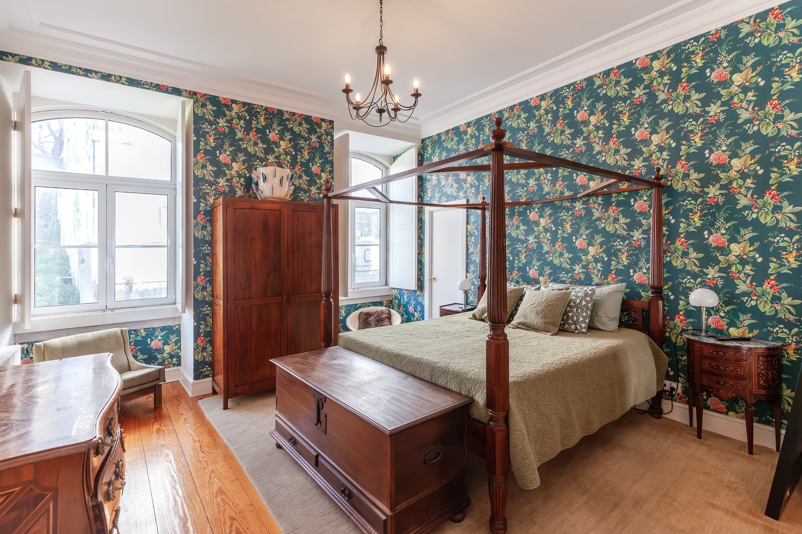 Elegant bedroom with four-poster bed and floral wallpaper