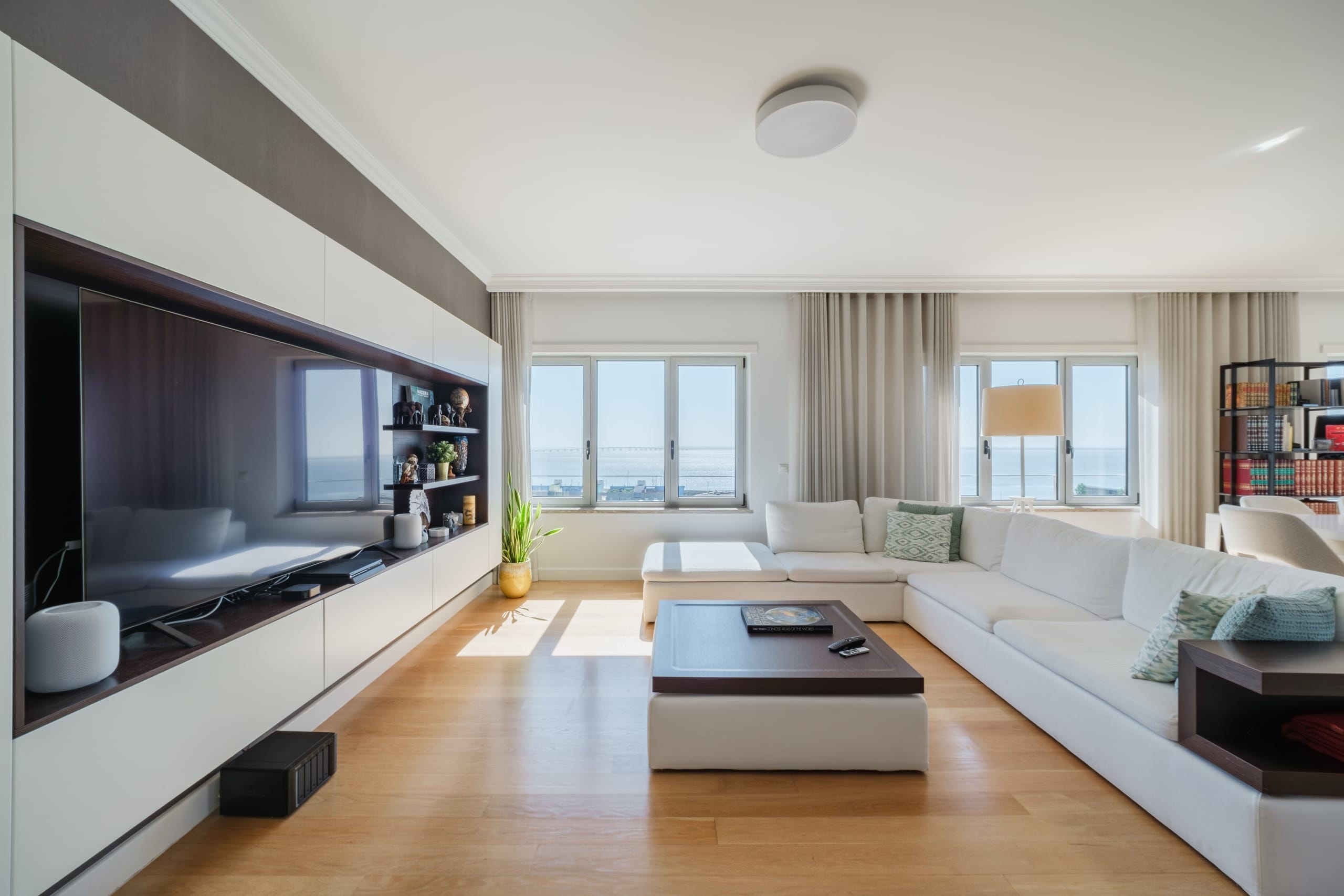 Modern living room with white sofa and sea view